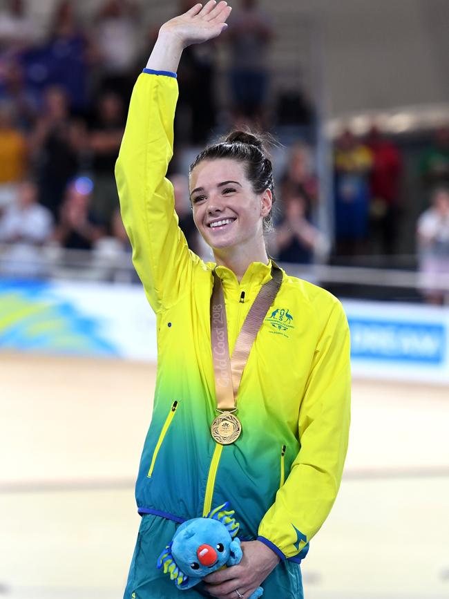 Amy Cure acknowledges the crowd after the gold medal presentation on day four of the Commonwealth Games on the Gold Coast. Picture: AAP/DAN PELED