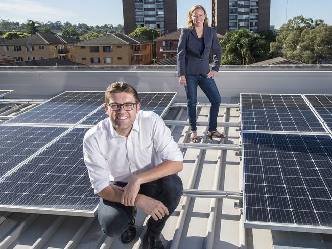 NORTHERN DISTRICT TIMES/AAP. Ryde mayor Jerome Laxale (L) and Cr Edwina Clifton (R) pose for a photograph near solar panels on the roof of Ryde Community Centre at West Ryde on Friday, 17 April, 2020. The council has installed a solar panel system to harvest green energy for the community centre. (AAP IMAGE / Troy Snook)