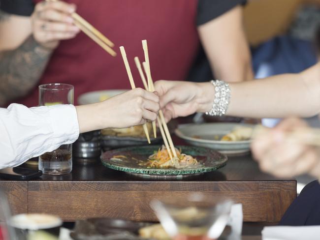 Group of friends eating in asian restaurant