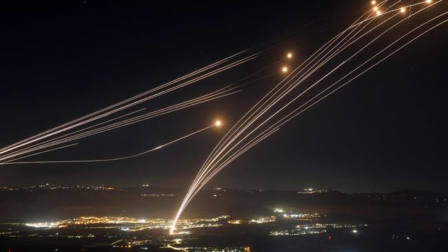 Rockets fired from southern Lebanon are intercepted by Israel's Iron Dome air defence system over the Upper Galilee region. Picture: AFP.