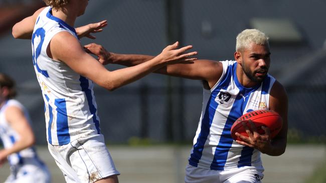 VFL: North Melbourne’s Tarryn Thomas fends off his own teammate. Picture: Hamish Blair