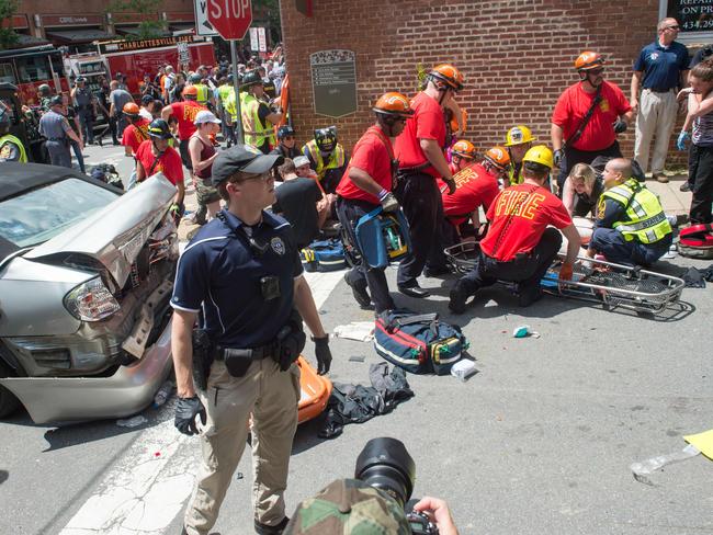 A woman receive first-aid after a car ran into a crowd of protesters in Charlottesville. Picture: Paul J Richards/AFP