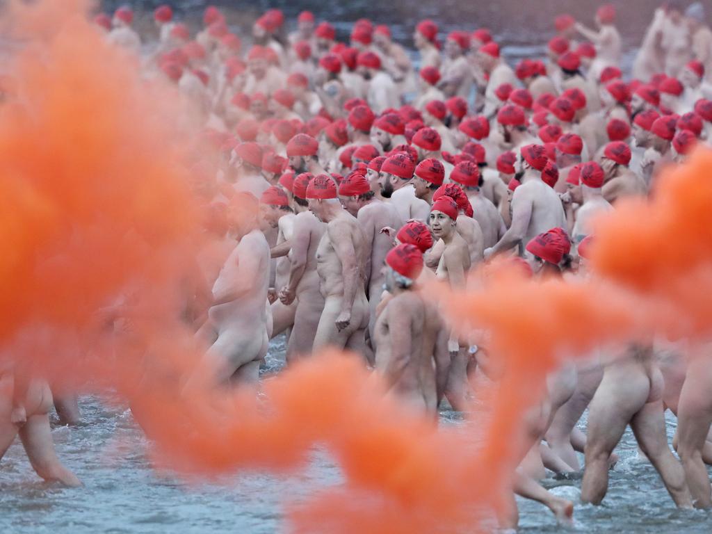 DARK MOFO 2019: Participants of the nude solstice swim brave the cold water at dawn at Long Beach, Sandy Bay. Picture: LUKE BOWDEN