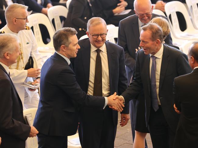 Labor leader Anthony Albanese attends a Good Friday Liturgy in Punchbowl, New South Wales during the federal election campaign. Former Prime Minister Tony Abbott shakes the hand of Labor MP Jason Clare. Picture: Toby Zerna