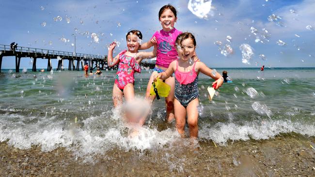 Sisters Quinn, 5, Ellliot, 8, and Darcy, 3, cool off at Henley Beach as the heat starts to escalate. Picture: Tricia Watkinson