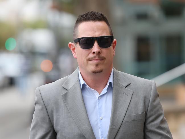 ADELAIDE, AUSTRALIA - NewsWire Photos May 4 2023: Benjamin McLeod is seen outside the Adelaide Magistrates Court. He is a South Australian Police officer charged with multiple assaults that allegedly occurred while he was taking part in arrests. NewsWire / David Mariuz