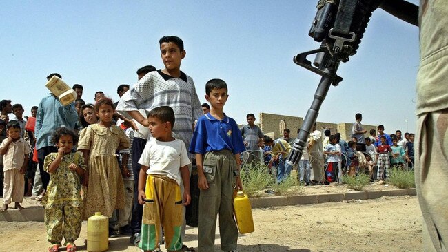 Iraqi children queue for water in Fallujah, June 15, 2003. Picture: EPA/The Times