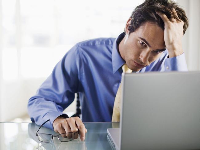 Frustrated businessman with laptop computer