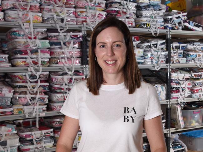 Carly Fradgley the founder of "Baby Give Back", a charity that helps disadvantaged families with small children pictured at their West Burleigh warehouse. (Photo/Steve Holland)