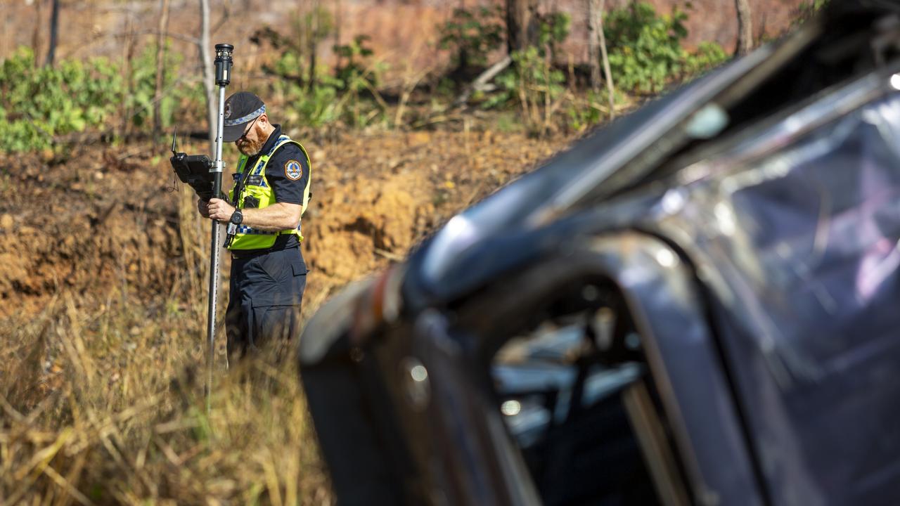 NT Police mark out the scene on the Stuart Hwy in front of the crash wreckage at Manton Dam. Picture: Floss Adams.