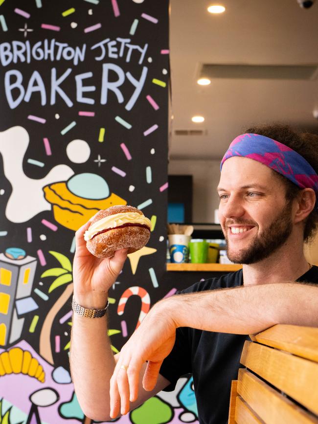 The way Brighton Jetty Bakery owner David Matkovic is looking at his Kitchener bun is the love every South Aussie feels for the sweet treat. Picture: Morgan Sette