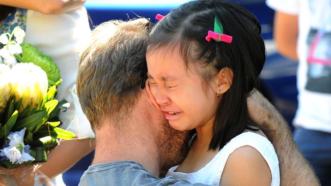 Josh Martin comforts little Rihanna Milabo. Photo: John Gass