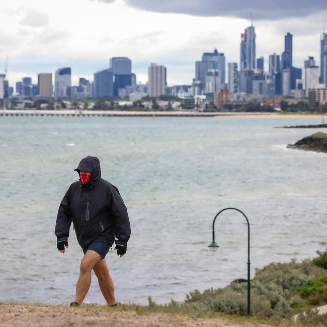 A man braves the rain to exercise near Elwood beach on a wet and windy day in Melbourne. Picture: NCA NewsWire/Ian Currie