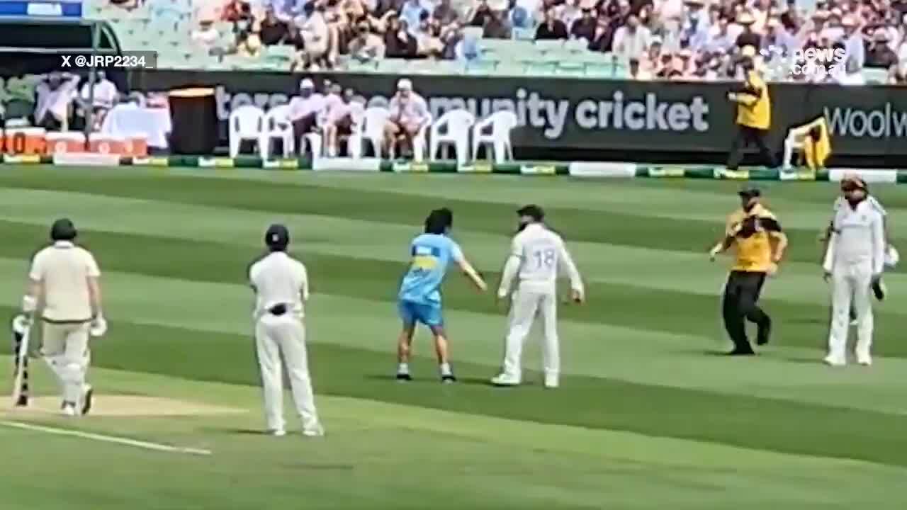 A pitch invader interrupts day 2 of the fourth Test at the MCG