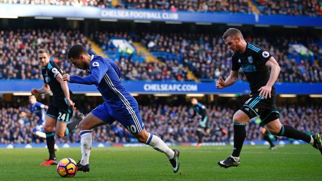 Eden Hazard (2nd L) is chased by Chris Brunt.