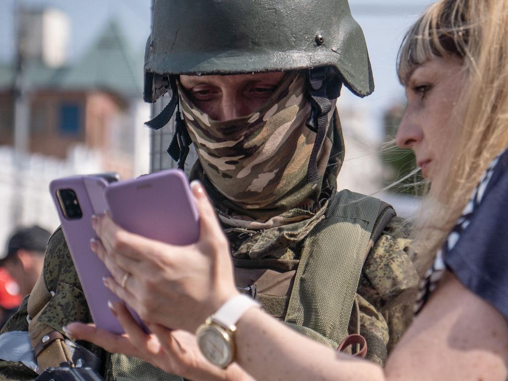 A woman speaks with a member of the Wagner Group in Rostov-on-Don. Picture: AFP