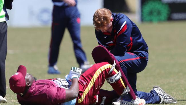 Newcomb batter Yemi Amusa is helped out by James Tilders. Picture: Mark Wilson