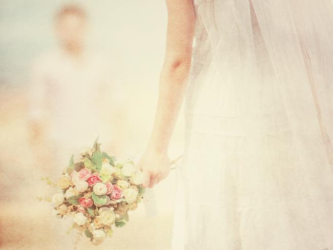 Bride with a bouquet on the beach. Vintage look.