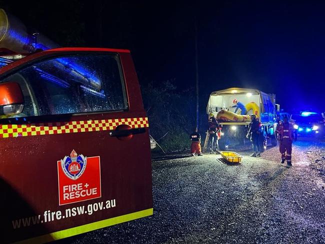 Time and date of Release: 1pm on March 26 2022Fire and Rescue NSW (FRNSW) has joined other first responders in a five-hour long mission to rescue an elderly man in rugged bushland, at Burrapine, west of Macksville on the state's mid-north coast.Around 7.20 last night, a FRNSW 'in-water' rescue team, SES volunteers and NSW Ambulance paramedics were faced with transporting an 82-year-old man suffering chest pains after recent heart surgery, out of a remote area.The FRNSW flood water experts, pre-positioned in the area to respond to emergencies during the weekend weather threat, had just completed a joint training drill last night when they were called into action.At 10pm, in darkness and heavy rain, paramedics and their patient were separated from the rescue party by rising floodwaters.The combined emergency team set up a base of operations downstream as it mapped out a plan to extricate the patient, whose condition they feared was deteriorating.Temporary lighting was established and a new State Emergency Service High Clearance Unimog vehicle was brought in to transport the man across the rugged bushland to a waiting ambulance.The patient was placed on a Stokes litter and carefully lifted onto the truck.The FRNSW flood water rescue team walked out in front, clearing a path for the vehicle as it crossed rapids to reach the patient and make the return journey.At one stage, the firefighters were confronted by a snake as they trekked through tall grass.The operation took about five hours to complete with the elderly man, who had been drifting in and out of consciousness, further stabilised and transported to hospital.In-water team 'Alpha' is one of four FRNSW flood rescue teams based at Coffs Harbour and Lismore during the current wet weather threat."It was another great example of our emergency services working together during these difficult times," FRNSW Station Officer, Matthew Gregory, said.