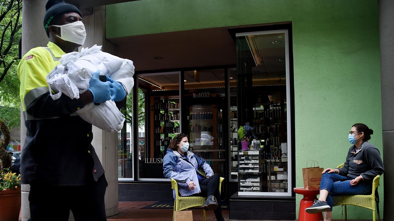 Friends wearing face masks practice social distancing in Virginia. Picture: Olivier Douliery/AFP