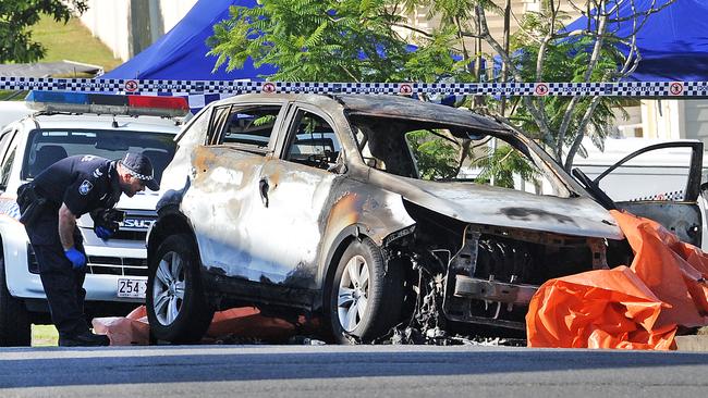 The burnt out car at Camp Hill. (AAP image, John Gass)