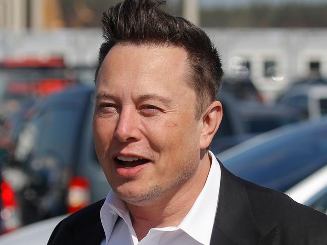(FILES) This file photo taken on September 3, 2020 shows Tesla CEO Elon Musk gesturing as he arrives to visit the construction site of the future US electric car giant Tesla, in Gruenheide near Berlin. - The boom in demand for placing small satellites into orbit has boosted interest in small rockets, but industry players do not think the niche will become a business segment of its own. (Photo by Odd ANDERSEN / AFP)