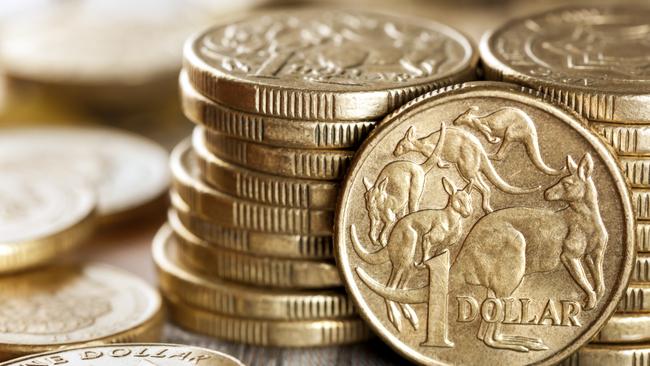 Stacks of Australian one dollar coins. Focus on front coin.