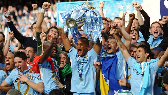 Manchester City players lift the Premier League trophy after the victory over Queens Park to secure their first title since 1968.