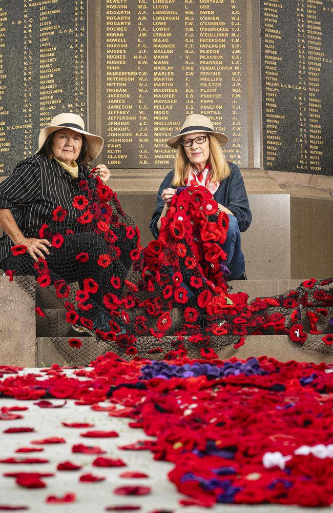 Jayne Hodge (left) and Chris Just install their "Memories in Bloom" with the help of Rotary Club of Toowoomba East at the Mothers' Memorial for Anzac Day, Wednesday, April 24, 2024. Picture: Kevin Farmer