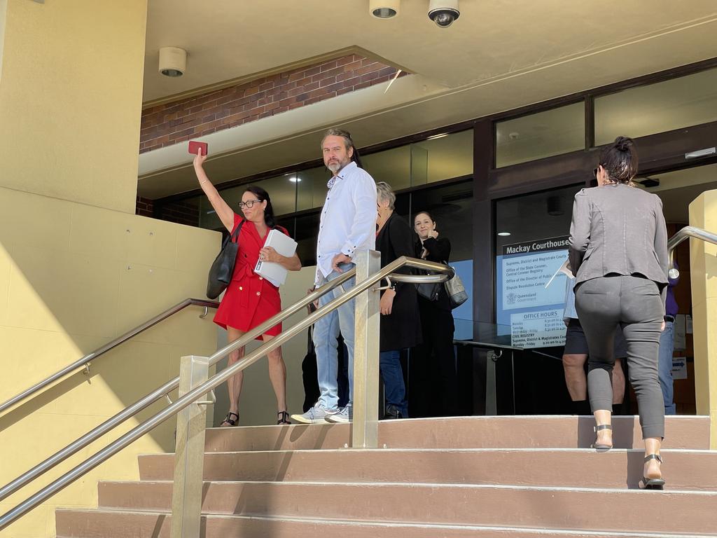 Hand in hand with her supporting band, Ms Polsoni left the courthouse. Photo: Fergus Gregg