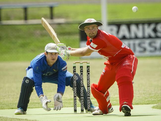 Sorrento batsman Leigh Poholke launches into a big shot as Langwarrin keeper Tom Hussey looks on. Picture: Valeriu Campan