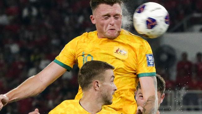 Australia's Harry Souttar (top) heads the ball during the 2026 FIFA World Cup Asian qualification football match between Indonesia and Australia at Gelora Bung Karno Stadium in Jakarta on September 10, 2024. (Photo by ADITYA AJI / AFP)