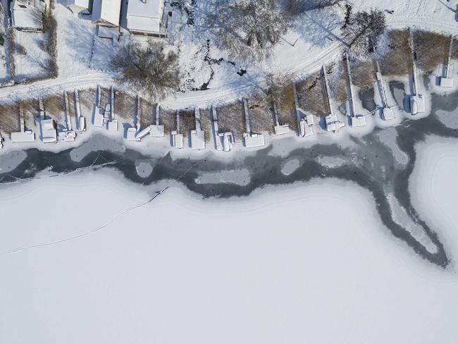 An aerial photograph shows snow-covered jetties on the shore of the frozen Lake Pecs at Orfu, 200 kms southwest of Budapest, Hungary, Wednesday, Feb. 28, 2018. Picture: AP