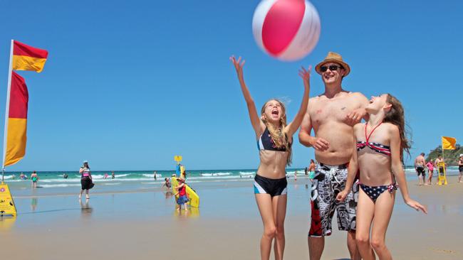 Bree Asbury, Mark Foster and Mercedes Foster of the Gold Coast having fun at Coolum Beach.