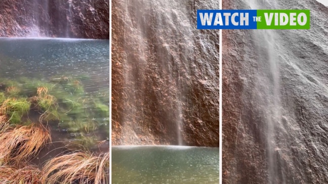 Rainfall at Uluru creates stunning waterfall scene