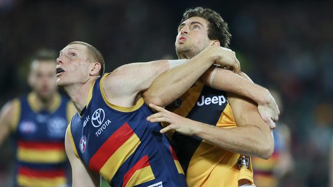 Bodywork ... Sam Jacobs of the Crows gets front position as he grapples with Richmond’s Shaun Hampson at Adelaide Oval. Picture: Ben Macmahon (AAP)