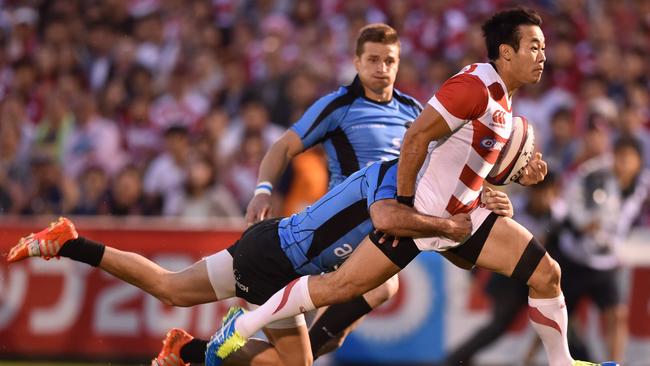 Japan’s Kenki Fukuoka is tackled by Uruguay’s Santiago Gilbernau.