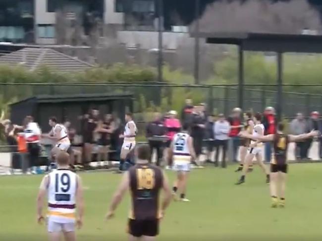 Templeton, near the boundary umpire in yellow, was caught on video flying over the fence.