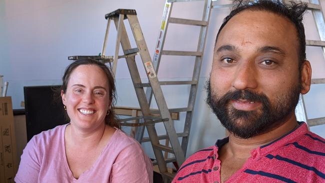 Satnam Singh Rath and his wife Erin Werner in their once flooded store, Masala Indian Fusion.