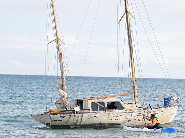 Samuel Evans kyaks out to the yacht that was stranded on the beach at North Haven after it was refloated on Thursday. Picture: Tom Huntley