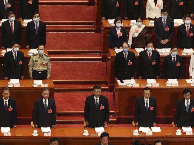 Chinese President Xi Jinping, center, and other Chinese leaders stand during the opening session of China's National People's Congress (NPC) at the Great Hall of the People in Beijing, Friday, May 22, 2020. (AP Photo/Ng Han Guan, Pool)