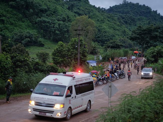 Locals surrounded the ambulance carrying one of the boys as it headed through mountainous northern Thailand to the hospital. Picture: Linh Pham/Getty Images