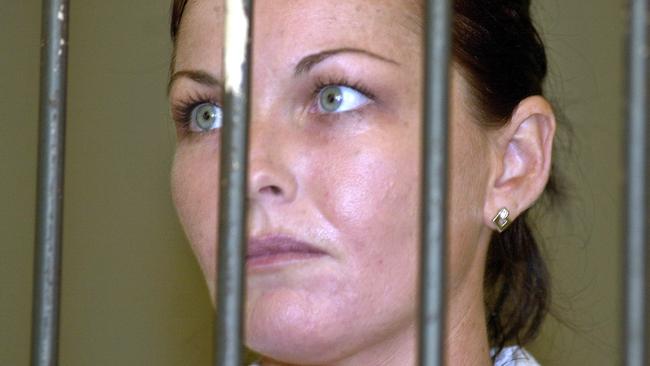 Convicted drug smuggler Schapelle Corby stands behind the bars at court's prison before her appeal trial in Denpasar's court, Bali, Indonesia in 2005. Picture: AP /Firdia Lisnawati.