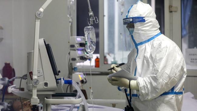 A medical worker records a patient's condition at Jinyintan Hospital in Wuhan. Picture: AP