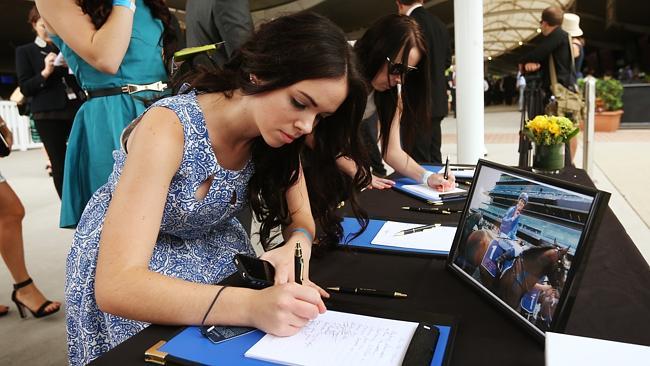 Golden Slipper Day at Rosehill Gardens: Kendell Nisbet (Tommy Berry’s future sister-in-law) signs a condolence books for Nathan Berry.