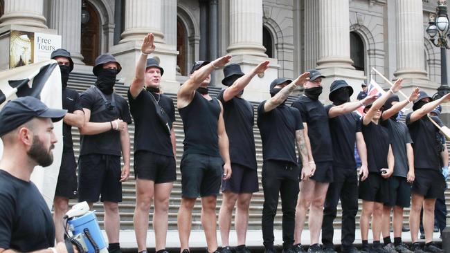 A far right wing group does Nazi salutes on the steps of Victorian Parliament. Picture: NCA NewsWire/David Crosling