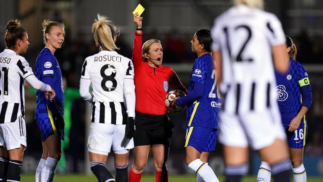 Sam Kerr (20) is booked by the referee for grounding a pitch invader (Photo by John Walton/PA Images via Getty Images)