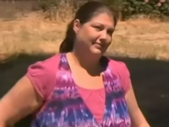 Hazel Passmore at a park in Adelaide talking to her lawyers.