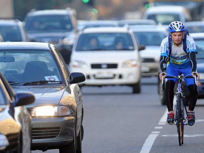 Commuter cyclist Arthur Konstad riding his bike home in city traffic from his work in the Adelaide CBD to Plympton.