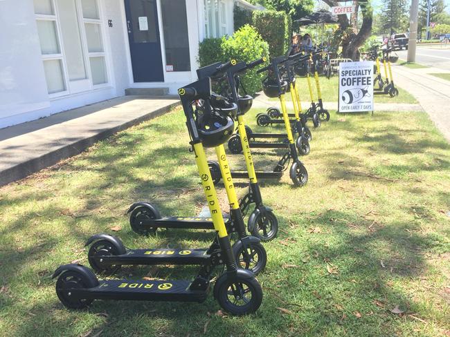 A row of RIDE e-scooters ready to be hired on Chevron Island. Photo: Talisa Eley